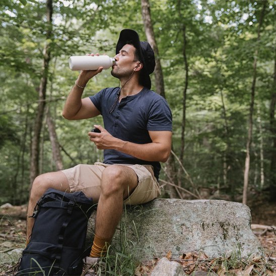 bouteille isotherme haute en couleur en forêt